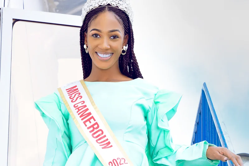 Julia Samantha Edima souriante avec couronne de Miss Cameroun et robe vert menthe